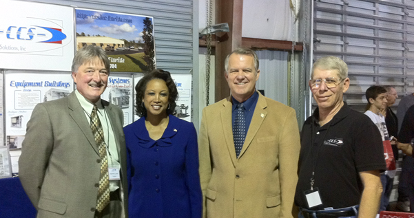 Jennifer cuts the ribbon for the jobs expansion of Custom Control Solutions, Inc.<br> who manufactures A3 Test Stand for NASA