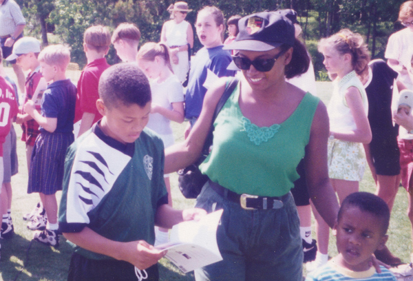 Young soccer mom Jennifer spending time attending soccer games with her sons